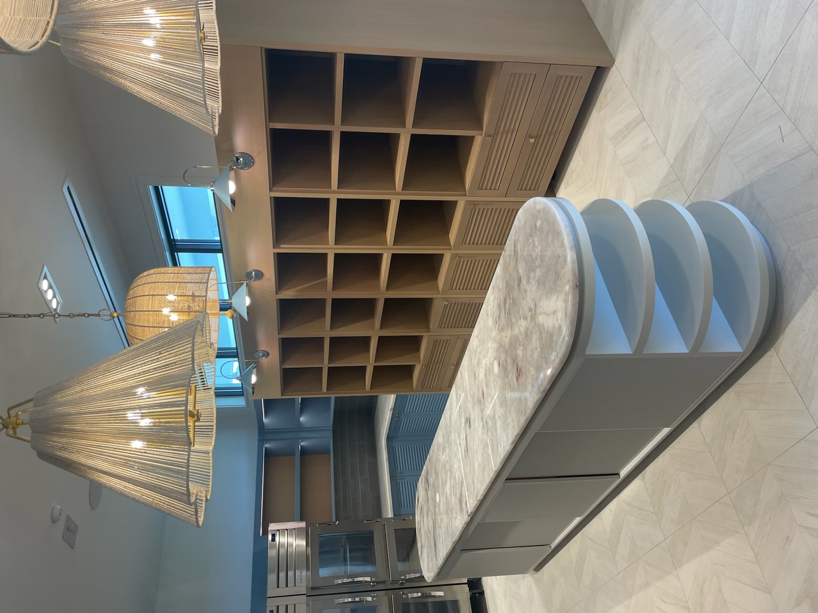 Custom island millwork and wood cubby wall unit built by Artec Woodworkers in Marco Island, Florida